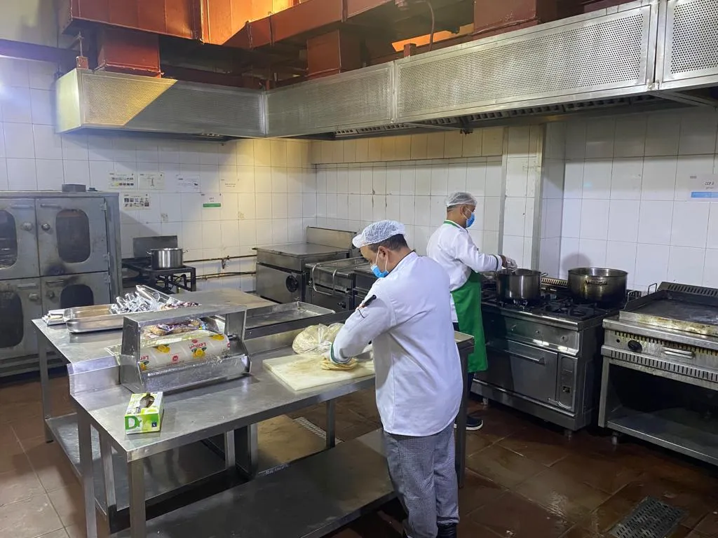 Kitchen team preparing food in a production kitchen