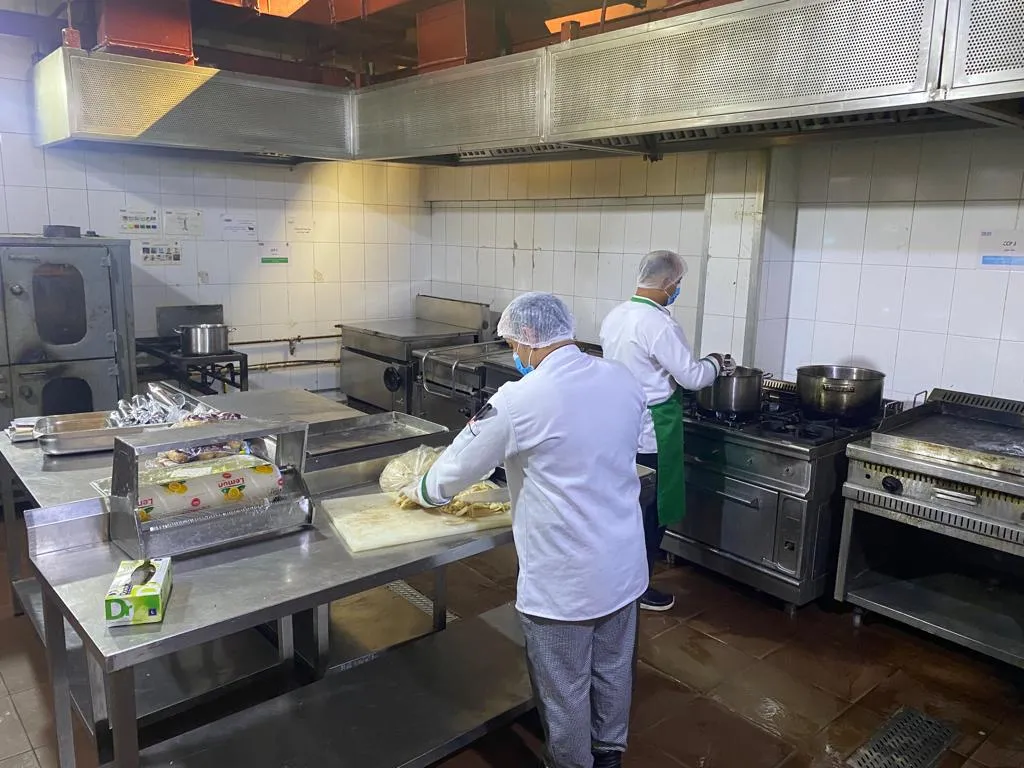 Kitchen team working at a commercial cooking line